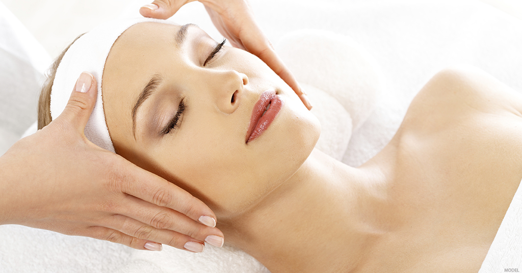 A woman's face is examined post facial treatment.