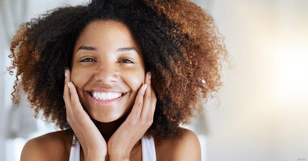 A woman looks happy with her laser skin resurfacing results