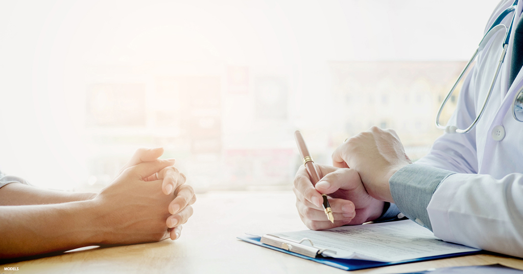 A patient discusses procedure options with their doctor before getting surgery.