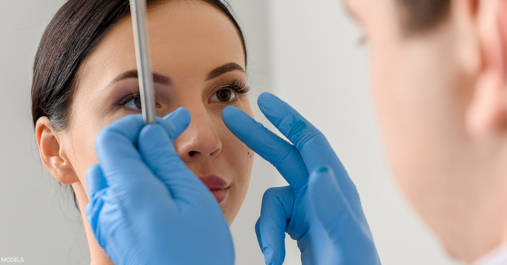 A woman is examined in her rhinoplasty consultation.