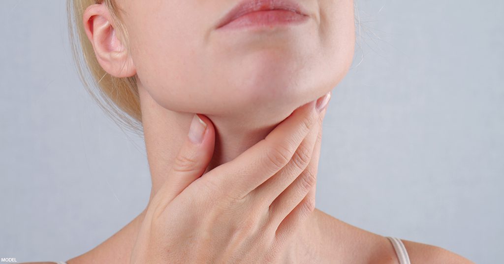 A woman holds her neck after receiving a non surgical neck treatment.