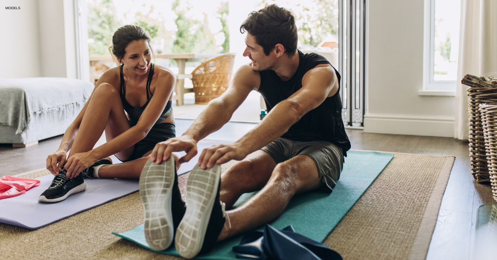 Couple working out together at home during COVID-19.