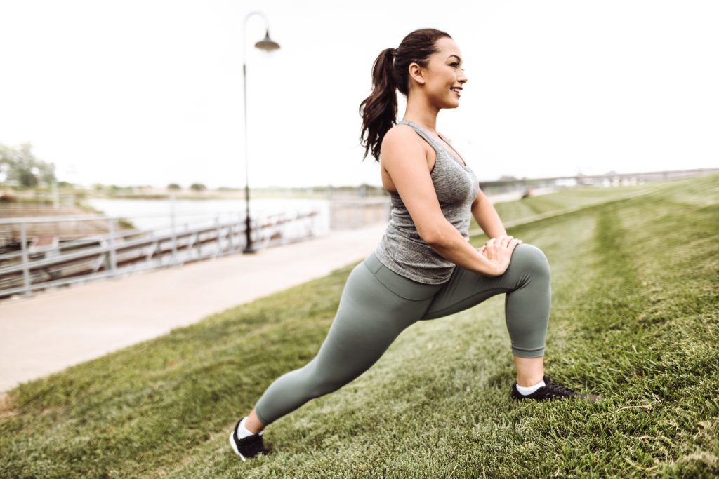 fitness woman stretching in the grass